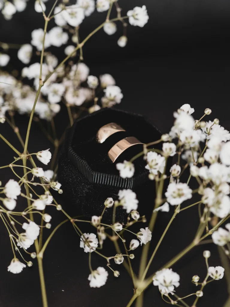 A wedding ring and flowers on a black background in Doncaster.