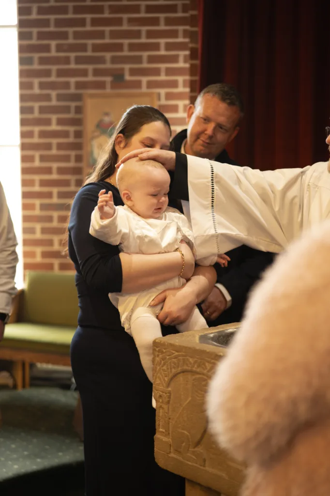 A woman holding a baby, symbolizing the bond of family.