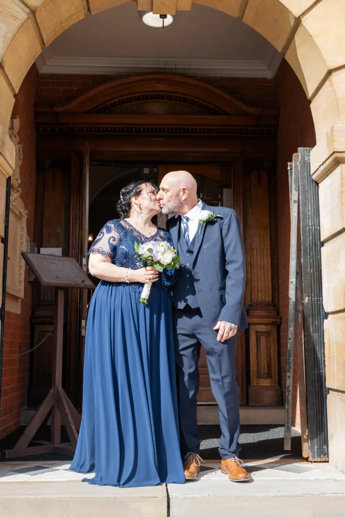 A bride and groom sharing a kiss outside Cleethorpes Registry Office