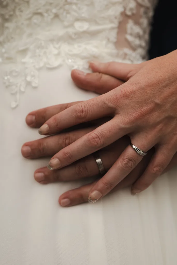 A close up of a bride and groom's hands at The Admiral Rodney Hotel.