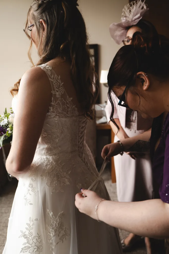A bride putting on her wedding dress at The Humber Royal Hotel.