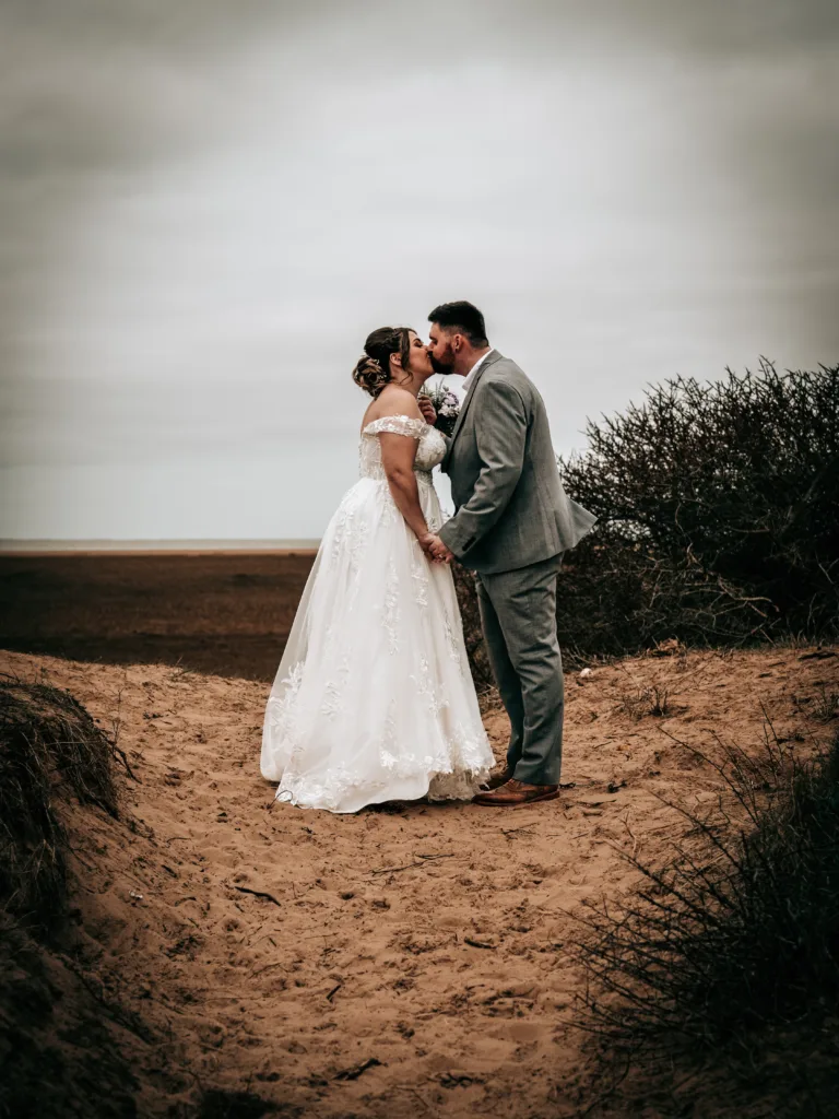 A bride and groom kissing in Cleethorpes.