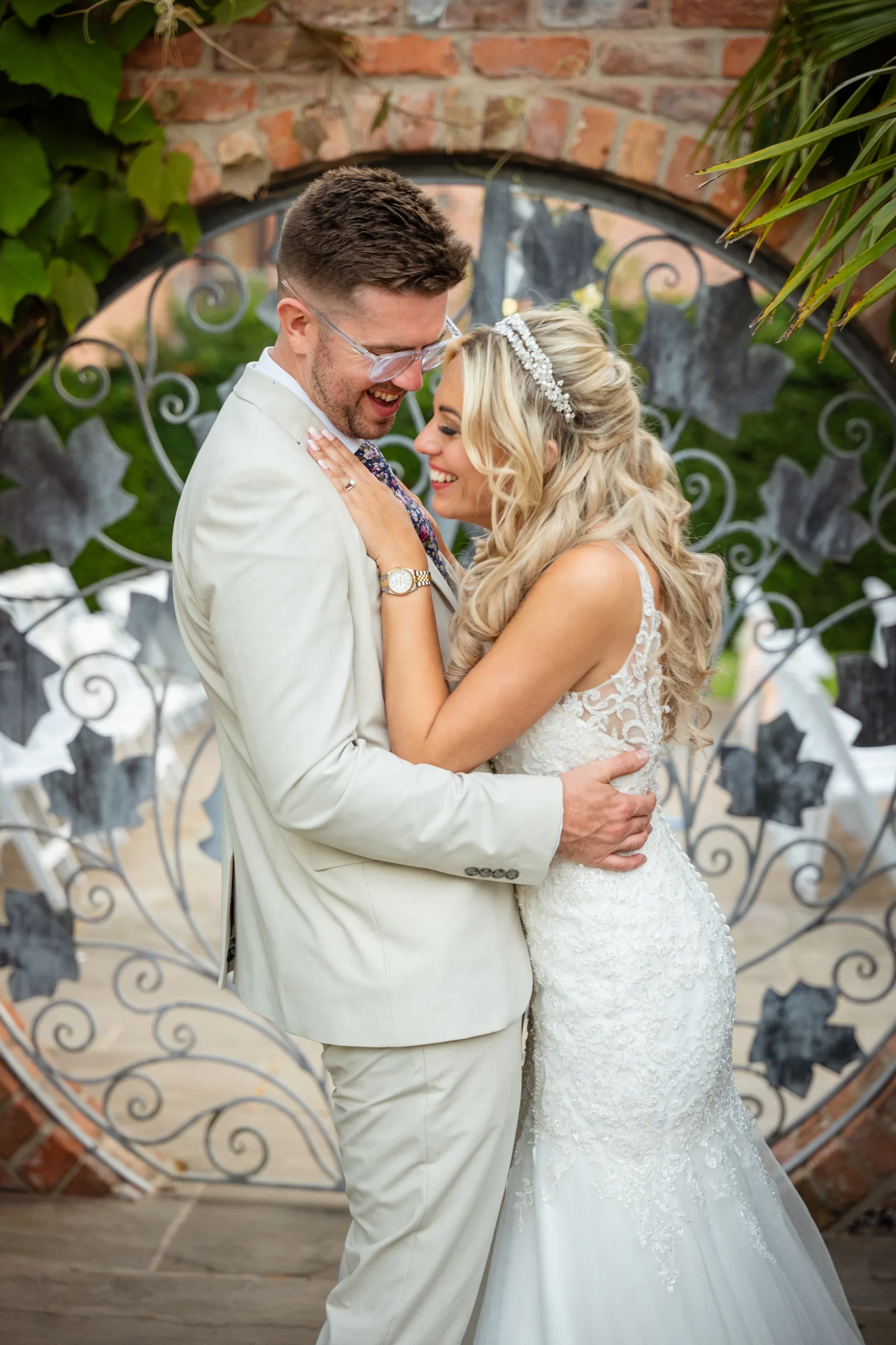 A bride and groom embrace in front of a beautiful sunset at the Mount Pleasant Hotel Doncaster.