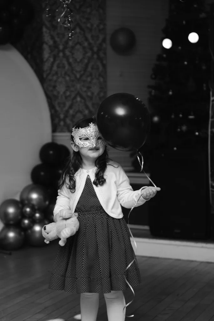A little girl holding a balloon at a family party in Cleethorpes.