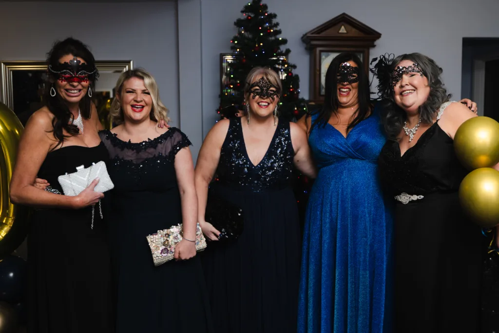 A group of women in black dresses posing for a photo at Mel's 40th birthday family party in Cleethorpes.