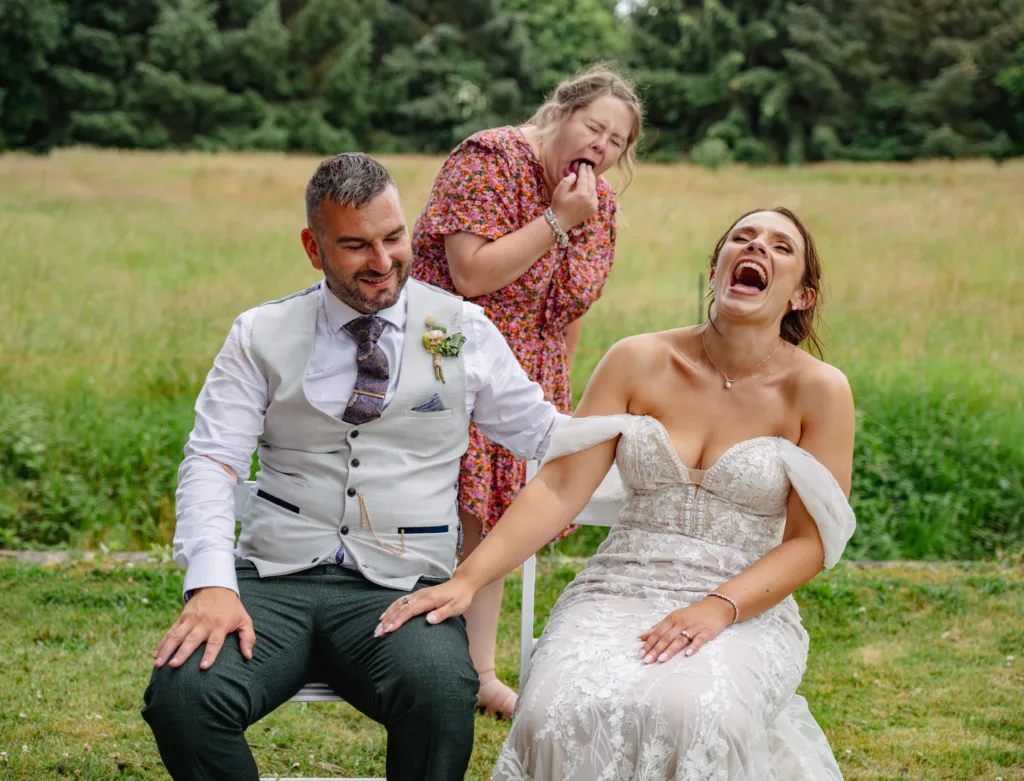 A bride and groom playing a game of roulette in a field while capturing the moment with a photo.