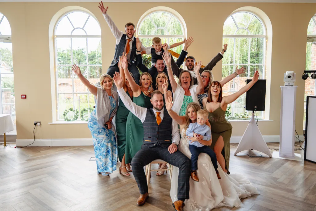 A wedding party posing for a photo during a lively game of roulette.