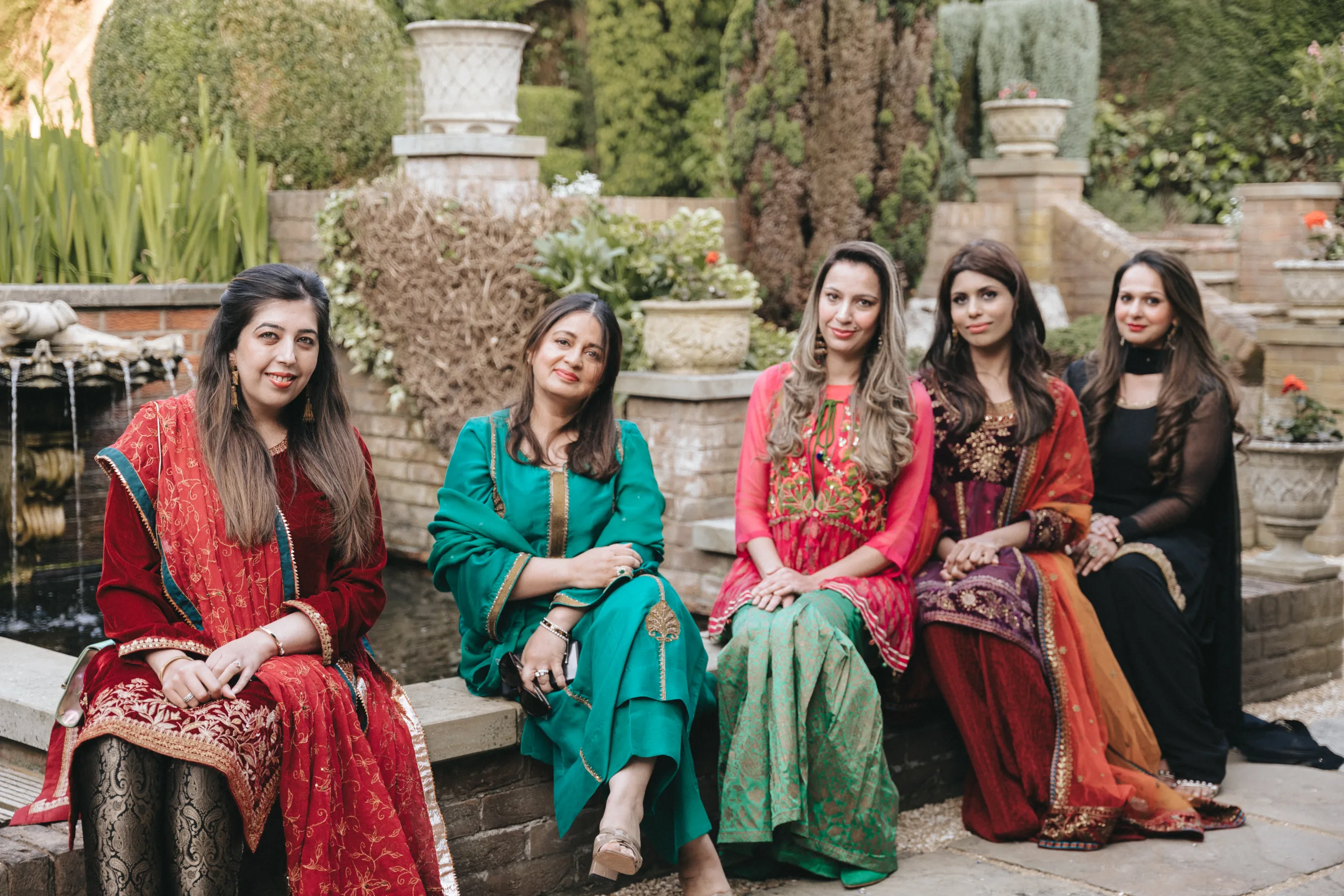 A group of Indian women posing in front of a fountain in Yorkshire.