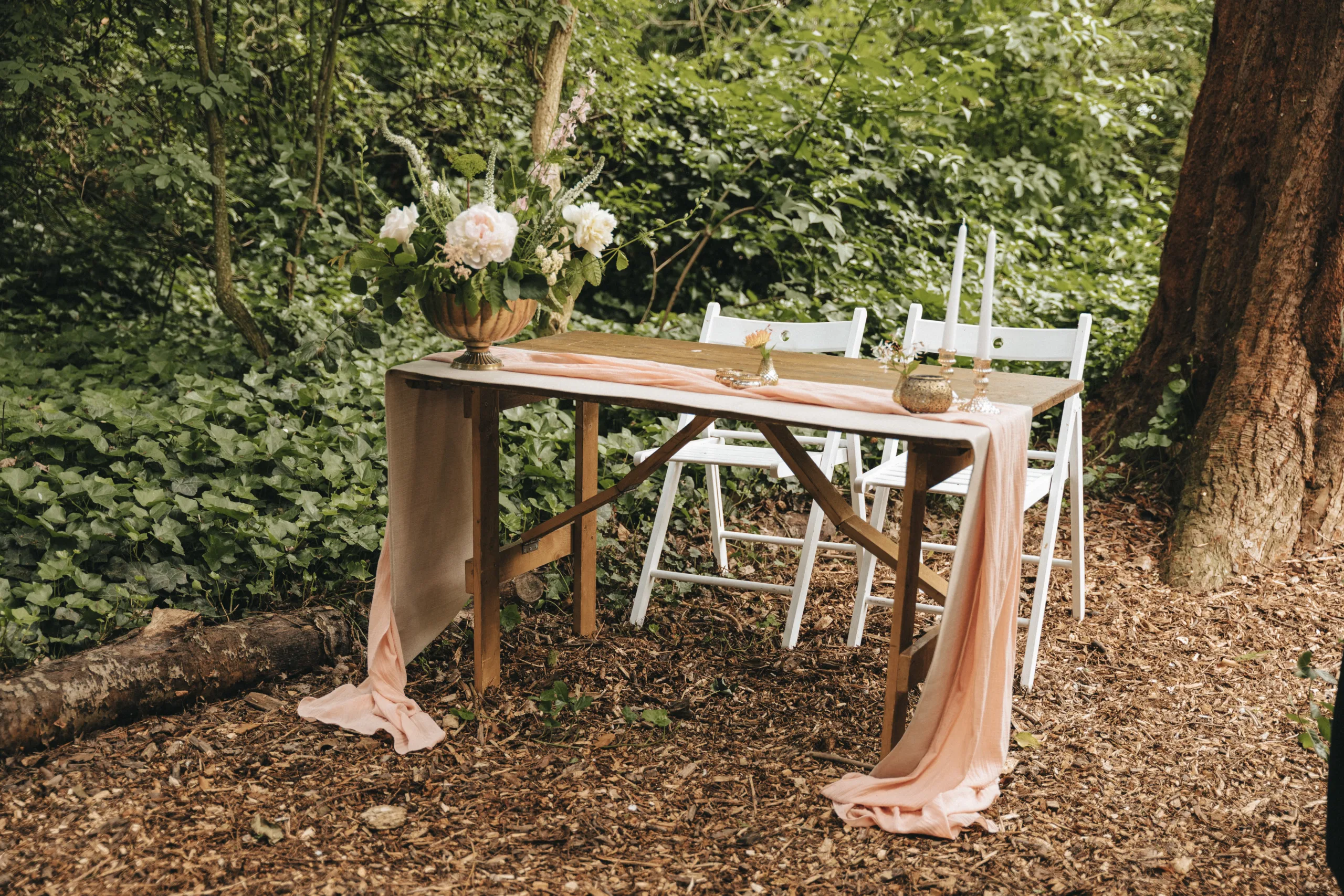 A table set up in a wooded area for a wedding in Lincolnshire.