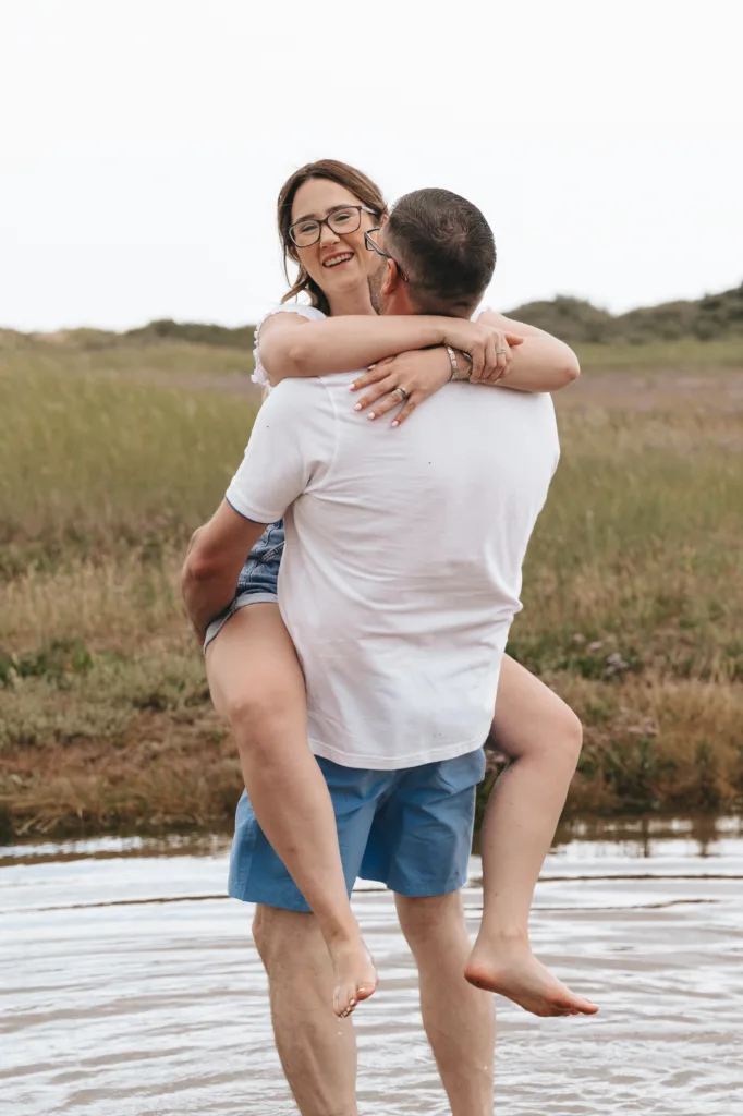 A man is being carried by a woman in the water in Lincolnshire, with the moment captured beautifully through photography.