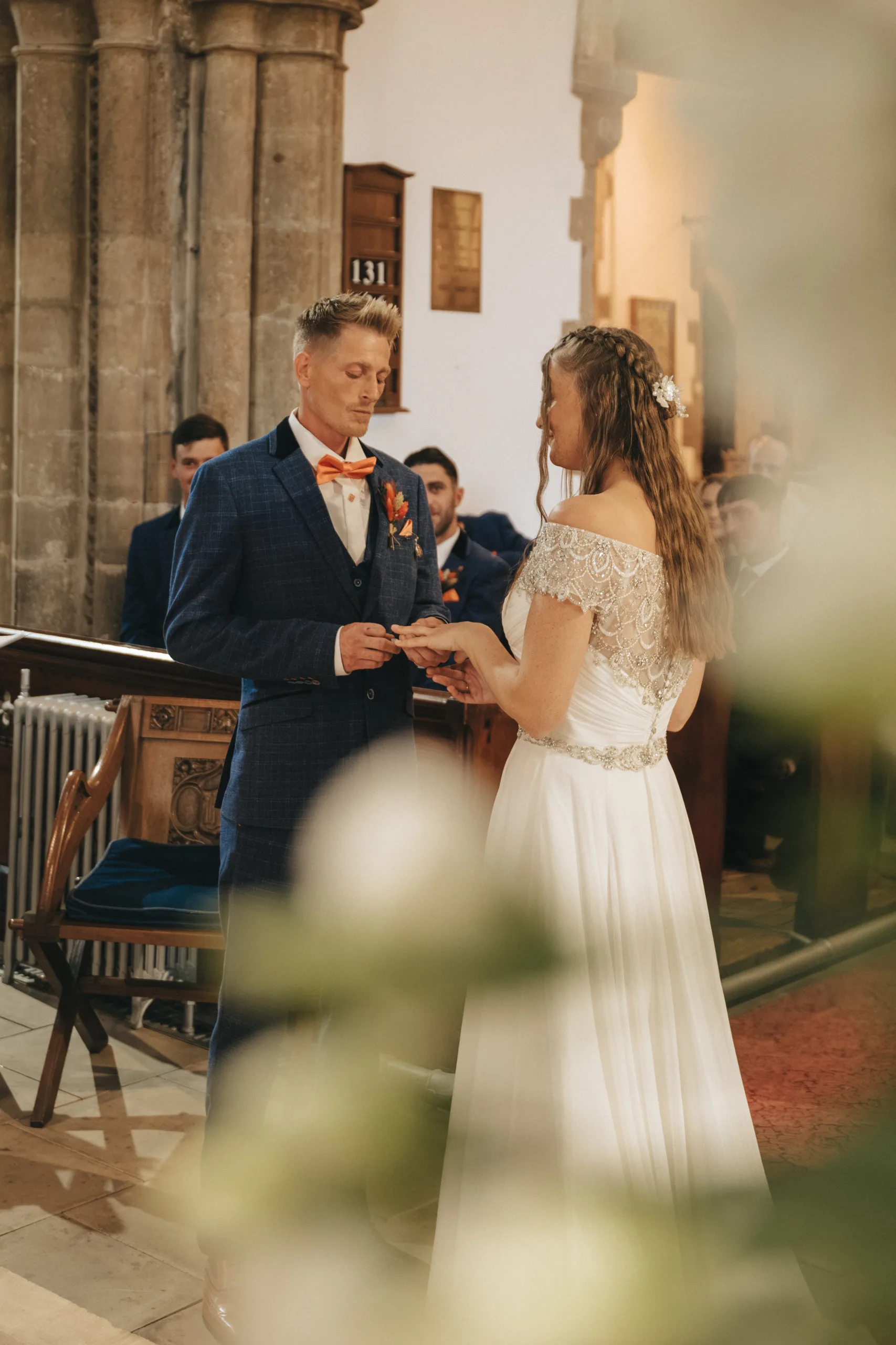 A bride and groom exchanging vows in a Lincolnshire church, captured by a photographer.