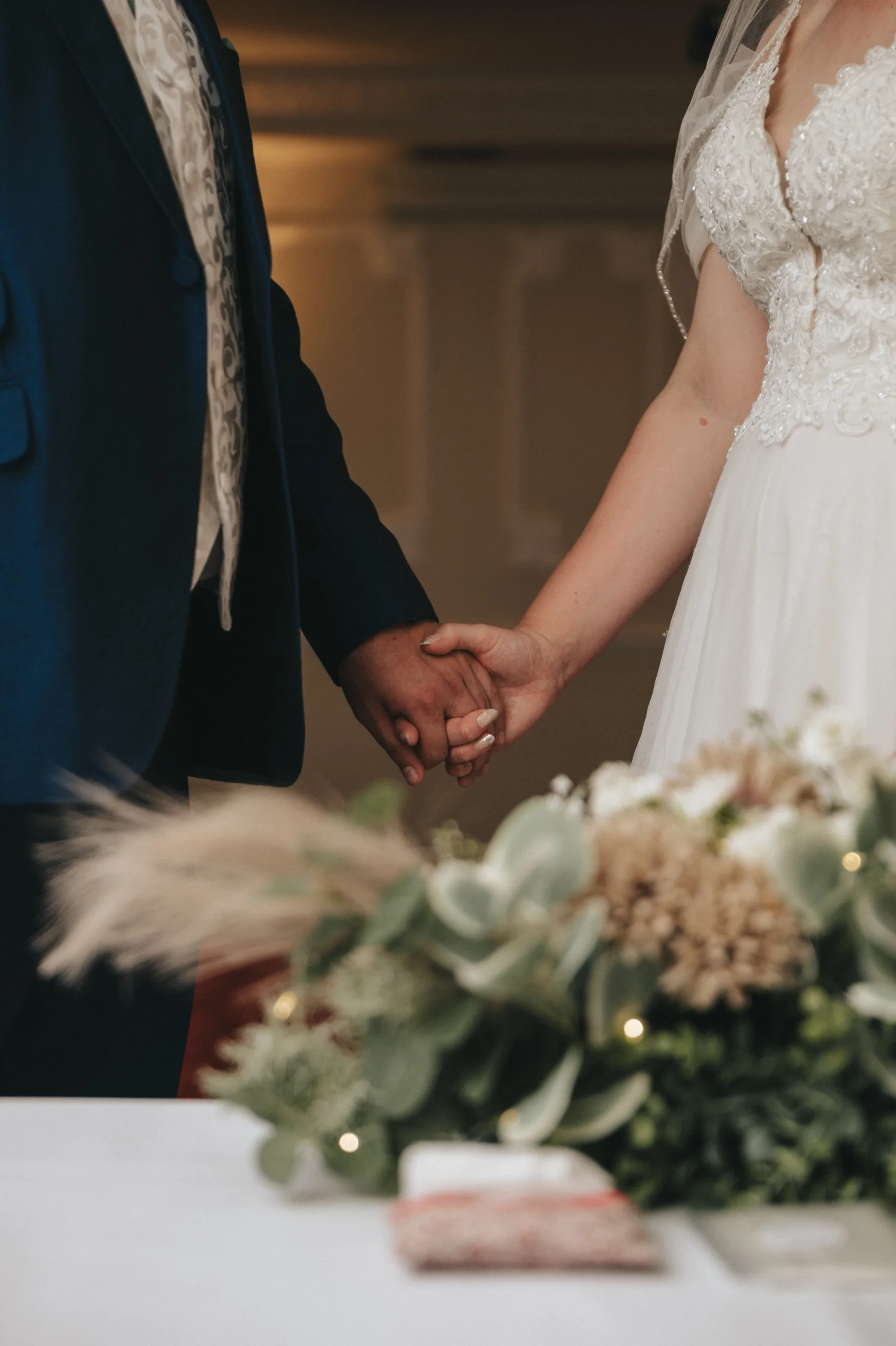 A bride and groom holding hands at their Lincolnshire wedding.