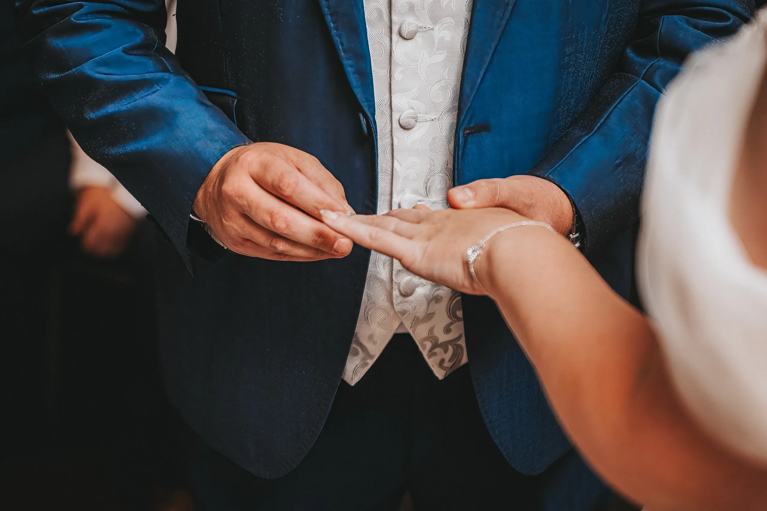 A Yorkshire bride is slipping the wedding ring onto her husband's finger as the photographer captures the moment.