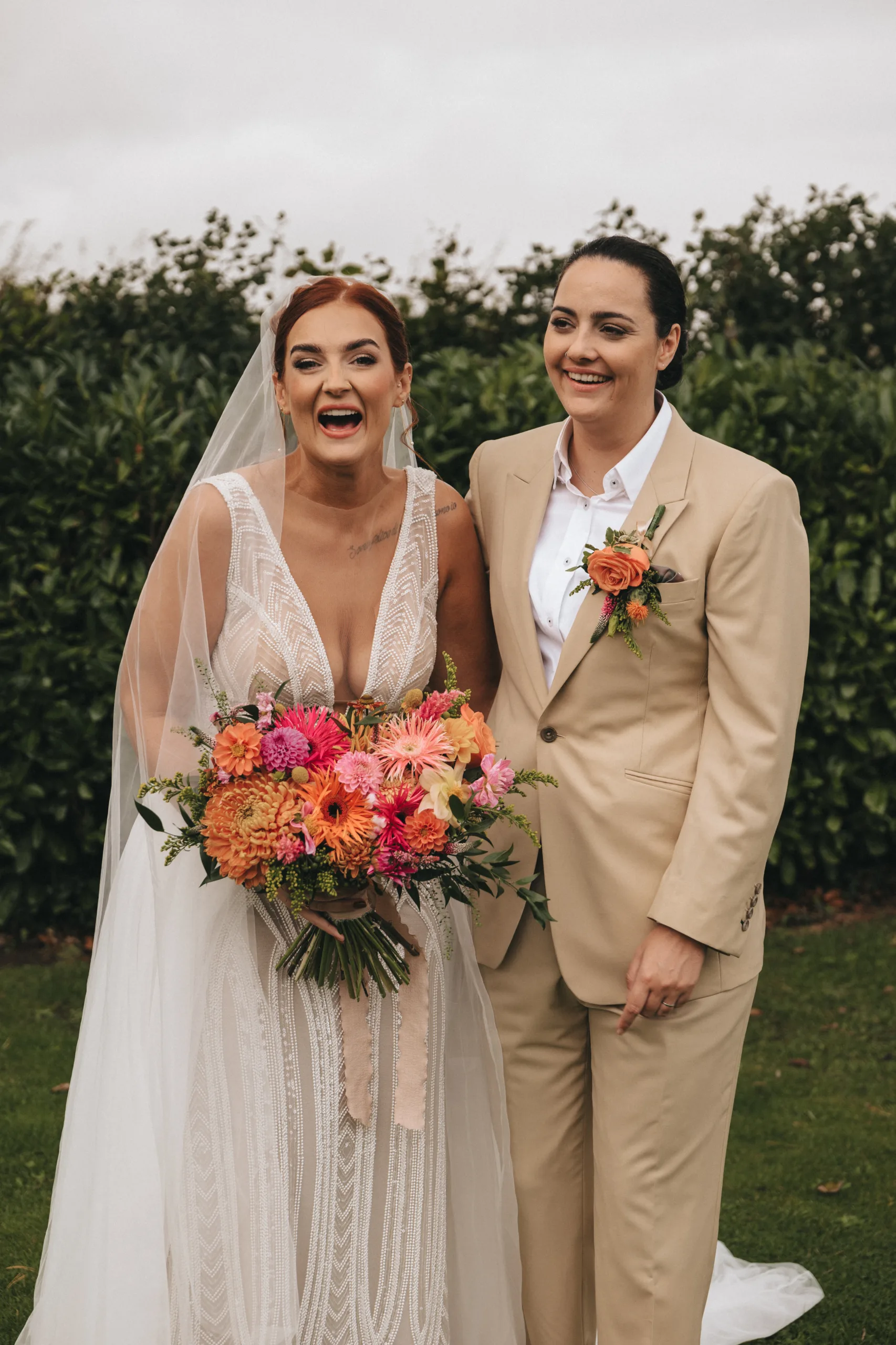 Two brides standing together in a field in Lincolnshire.