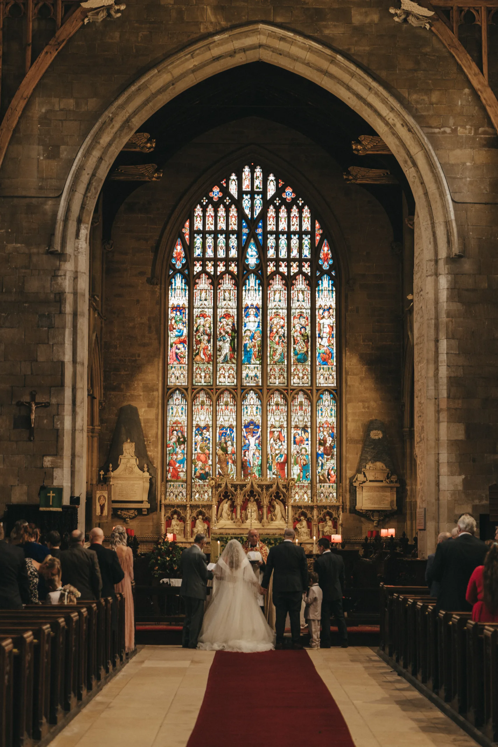 A bride and groom walking down the aisle in a church captured by wedding photography in Lincolnshire.