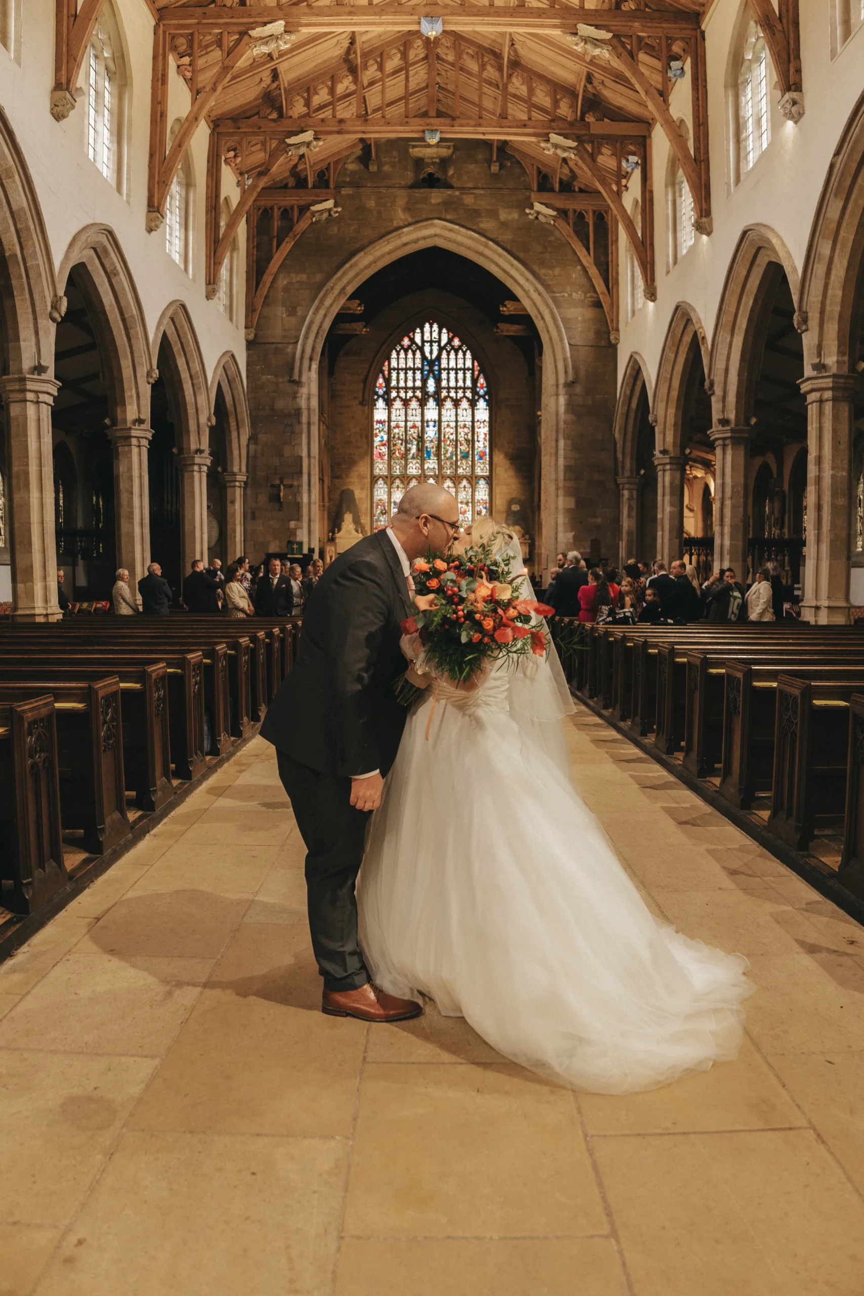 A bride and groom kissing in a Yorkshire church.