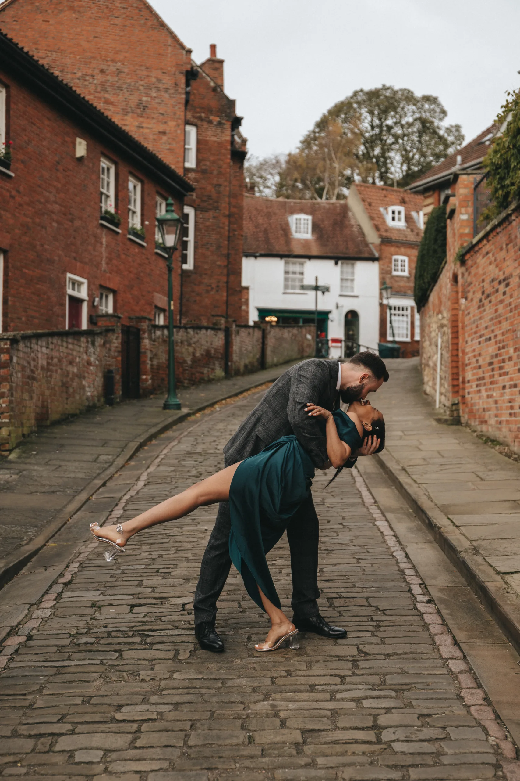 A couple kissing on a Yorkshire street, captured by a wedding photographer.