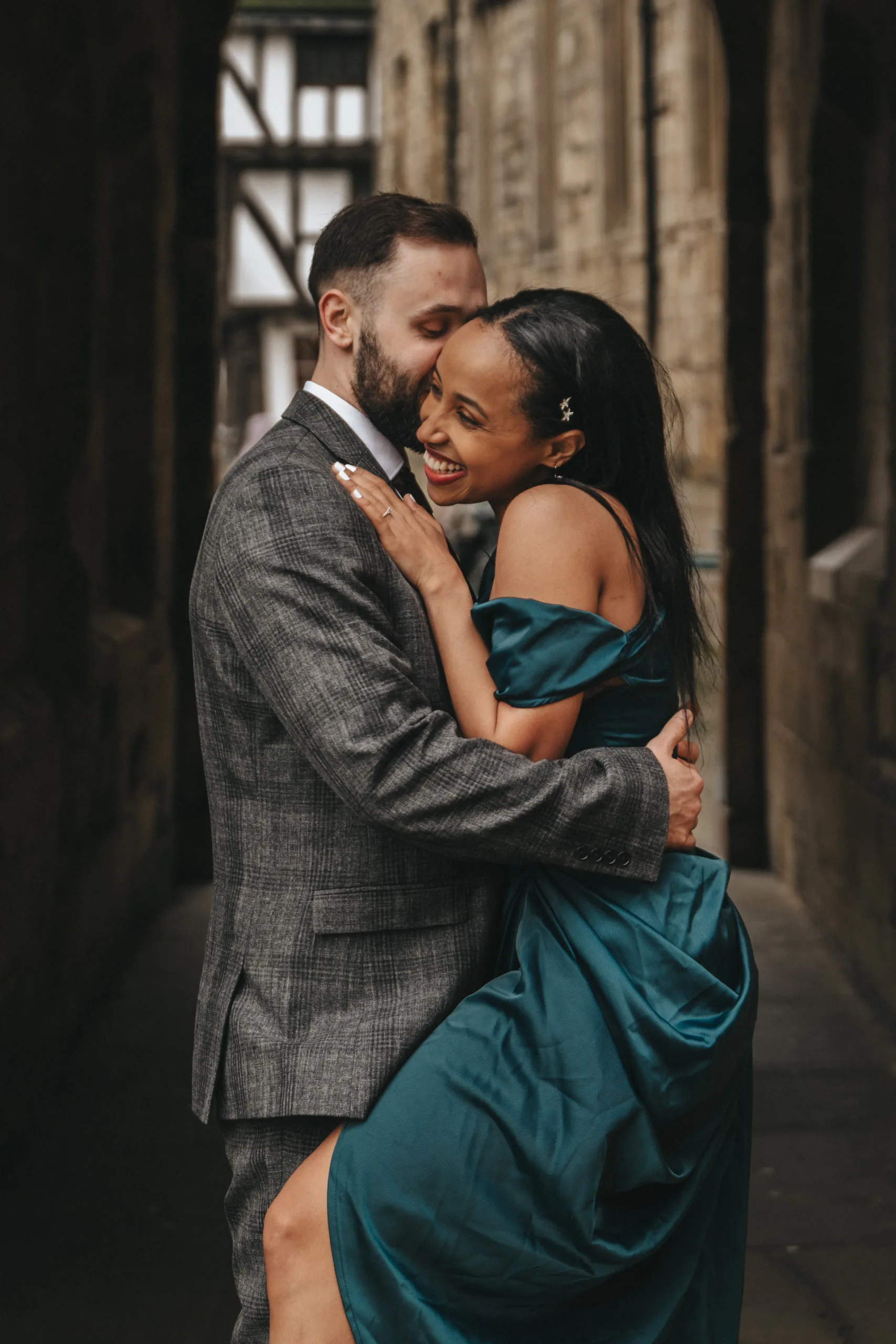 A couple embracing in an alleyway during their engagement session captured by a Lincolnshire photographer.