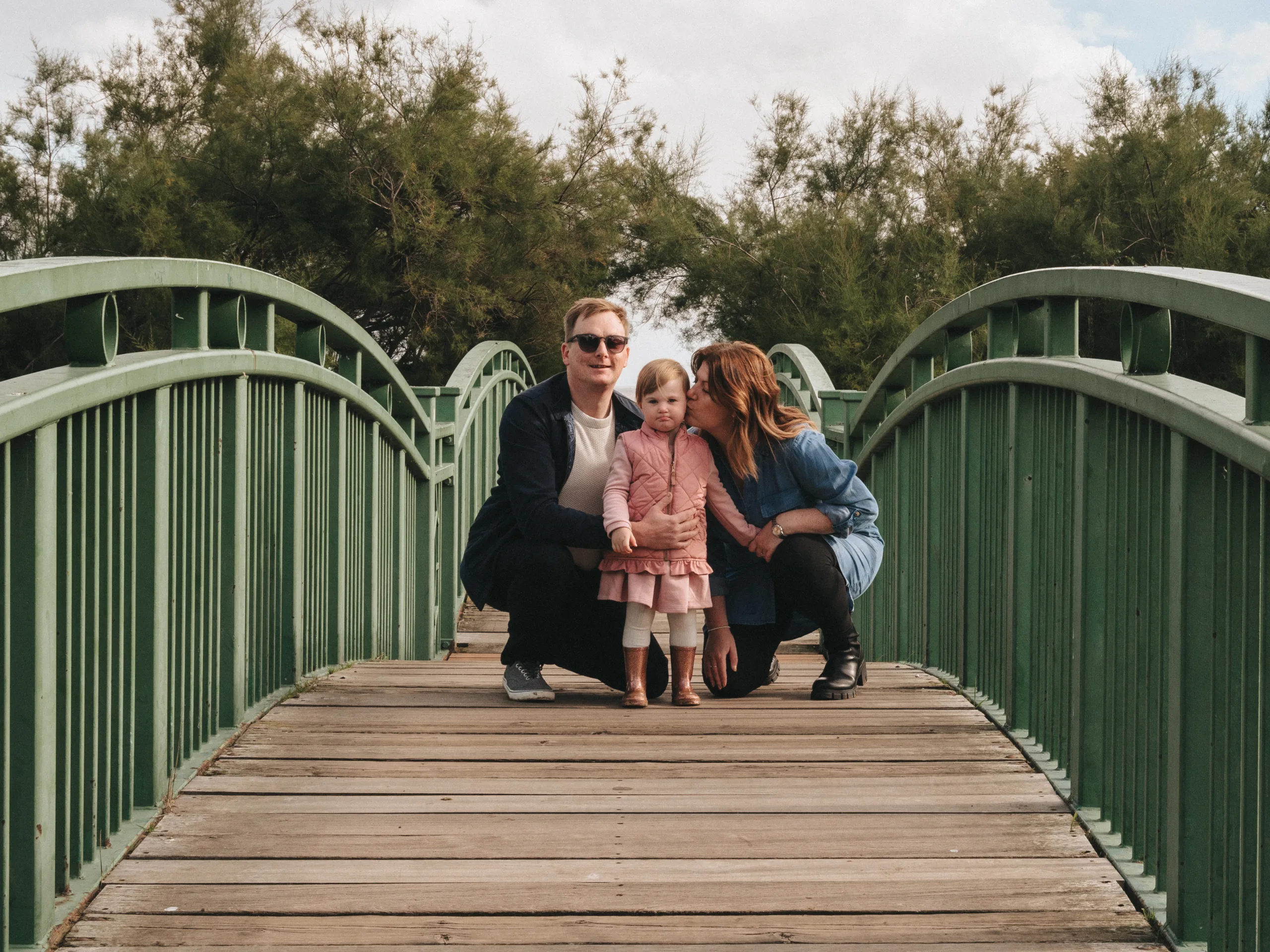 A family is posing on a green bridge in Lincolnshire.