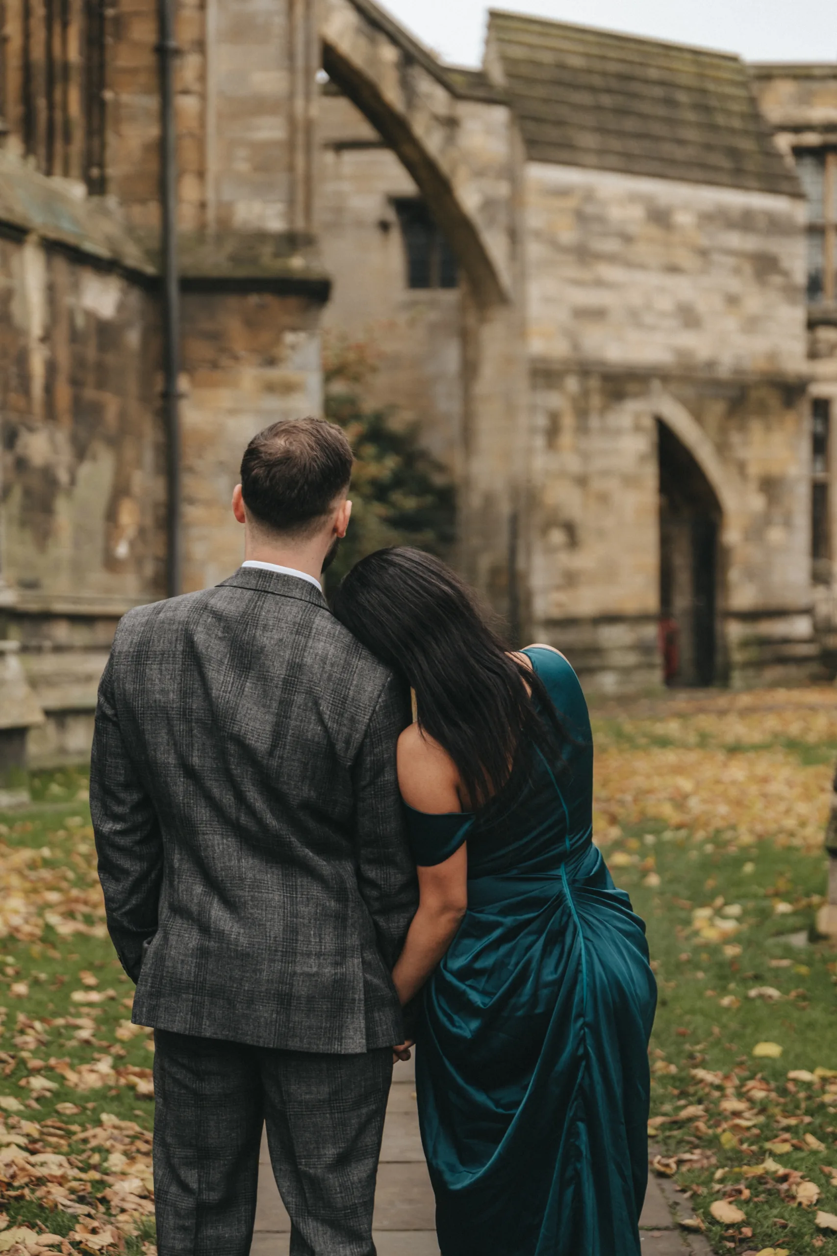 A bride and groom standing in front of an old building as captured by a photographer in Lincolnshire.