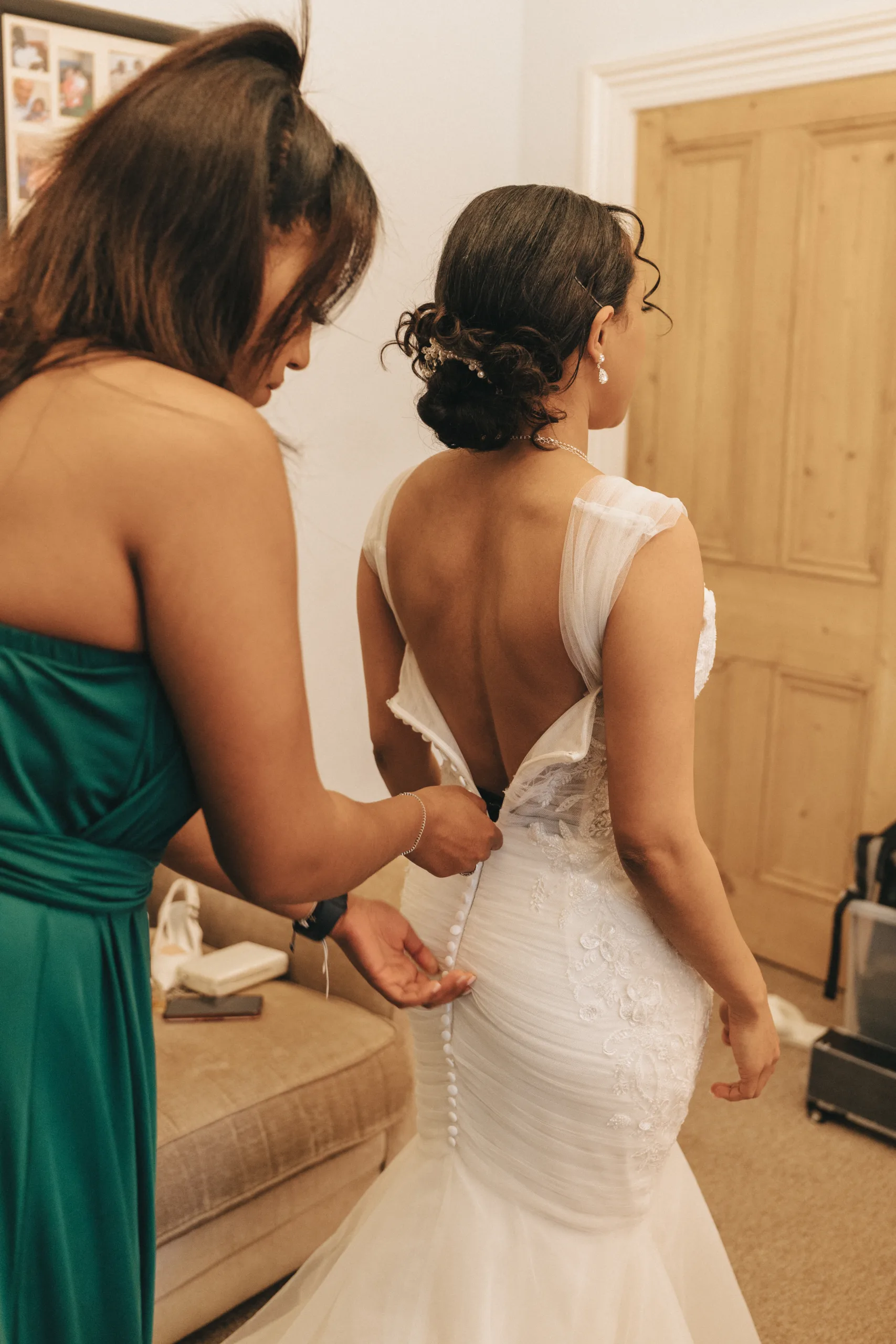 A bride getting ready in her wedding dress in Lincolnshire for photography.