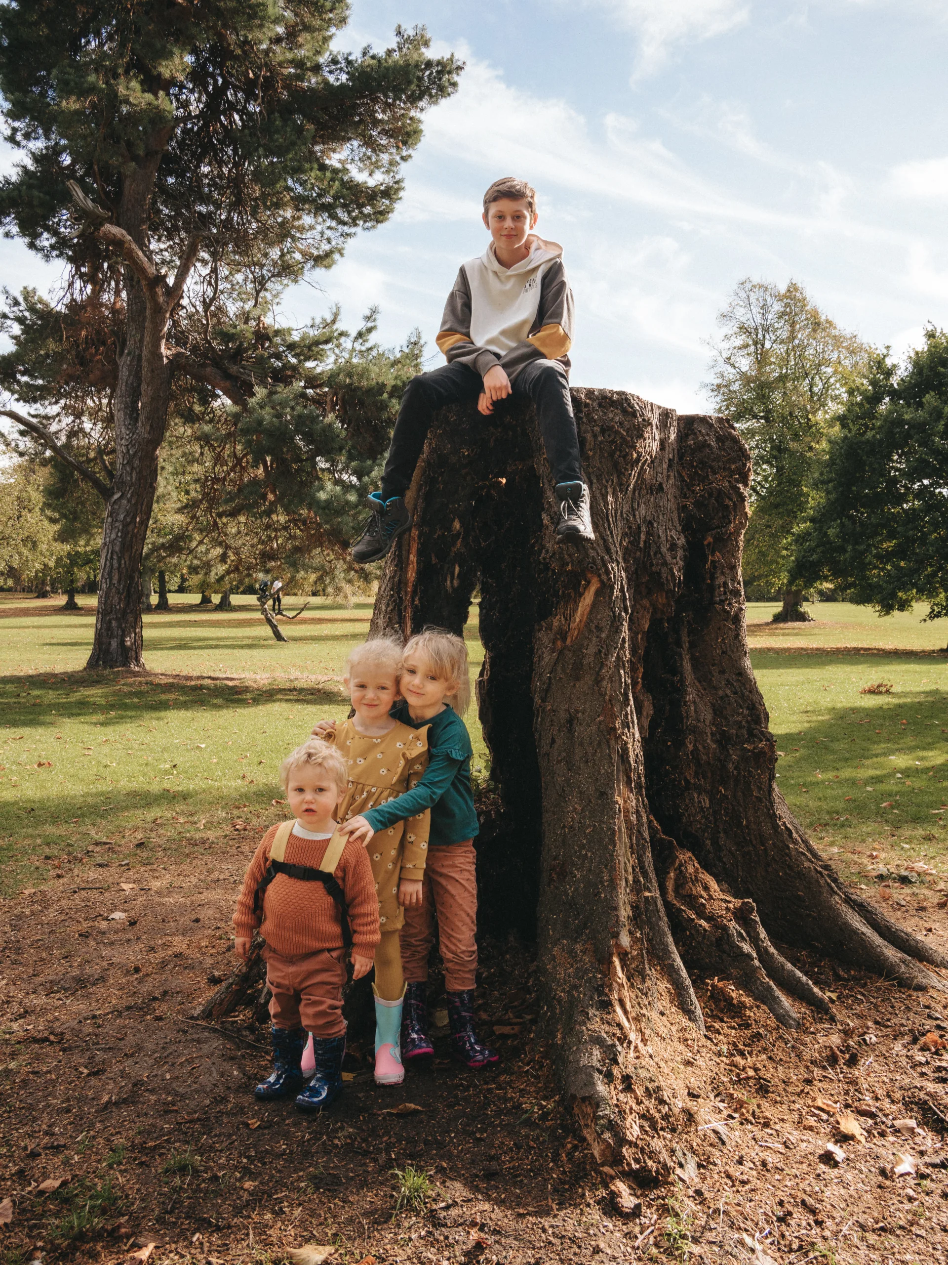 A group of children sitting on a tree stump in Lincolnshire.