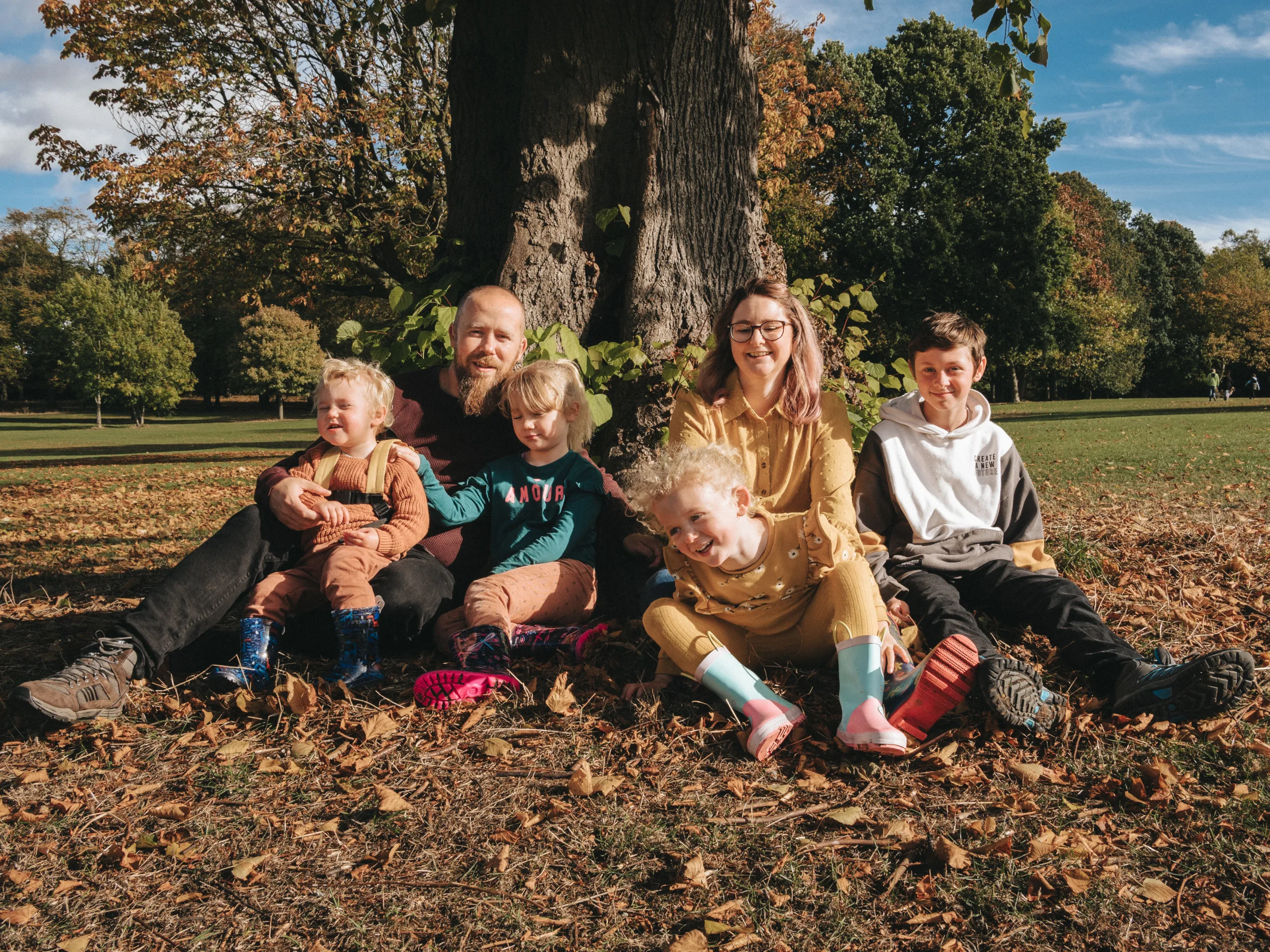 A family enjoys a picnic under a tree in a park in Lincolnshire.