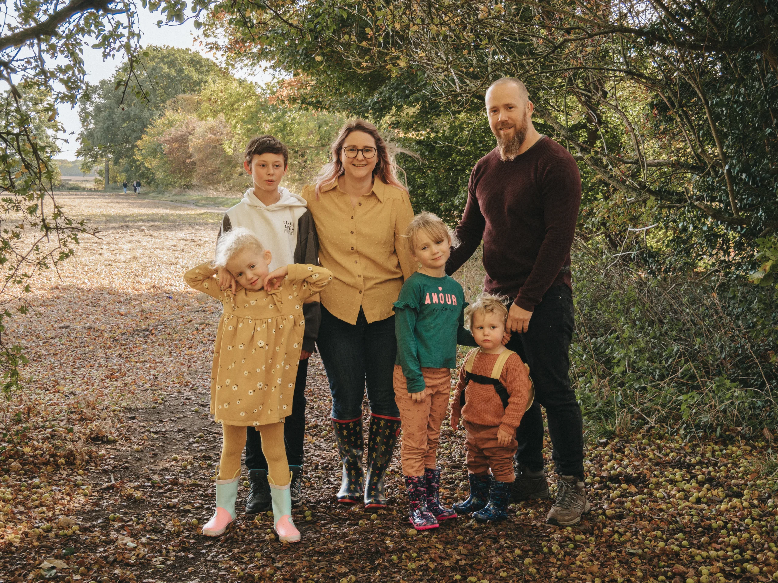 A family posing for a photo in a wooded area in Lincolnshire.
