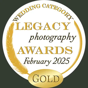 A round gold and white badge for the 2025 "WEDDING CATEGORY LEGACY photography AWARDS" features a gold feather along the left side, a gold oval at the bottom, elegant fonts, and a dark green background—perfect for your Page Footer. © Aimee Lince Photography - Wedding photographer in Lincolnshire, Yorkshire & Nottinghamshire