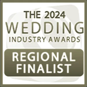 Square badge with the text "The 2024 Wedding Industry Awards Regional Finalist" in white and gold on a two-tone background. A faint, abstract floral design appears behind the text, framed by a thin gold border—ideal for your 2025 page footer. © Aimee Lince Photography - Wedding photographer in Lincolnshire, Yorkshire & Nottinghamshire
